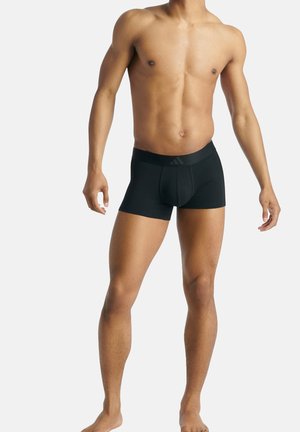 Schwarze Boxershorts aus einem glatten, dehnbaren Material mit körpernahem Schnitt und einem breiten, mit Markenlogo versehenen elastischen Bund.
