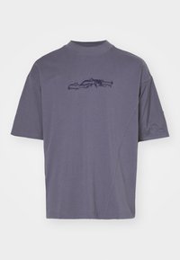 Camiseta corta de manga corta morada, fabricada en un tejido suave, que presenta un sutil bordado de la silueta de un coche en el frente y un diseño de corte relajado.