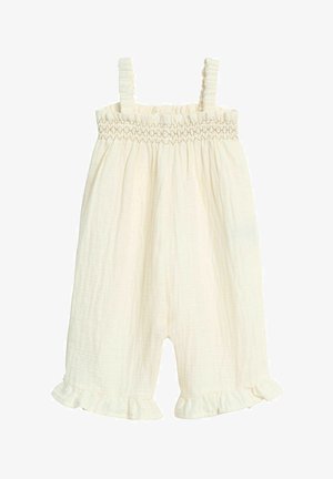Cremefarbenes Jumpsuit aus strukturiertem Baumwollstoff mit einem gerafften Oberteil, dünnen Trägern und einem Rüschensaum an den Beinen.