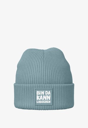 Blue knitted beanie with ribbed texture and a folded cuff featuring a rectangular patch with white text: "BIN DA KANN LOSGEHEN."