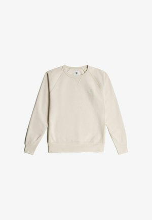 Light beige sweatshirt made of soft fabric, featuring a crew neck, raglan sleeves, and a small logo on the chest. Smooth texture.