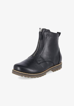 Bottine en cuir noir avec fermeture éclair à l'avant, semelle cousue marron et semelle extérieure en caoutchouc texturée pour une bonne adhérence.