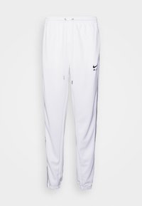 Vita sweatpants i mjukt material med elastisk midja, dragsko-detaljer och svarta logotypaccenter på låret och underbenet.