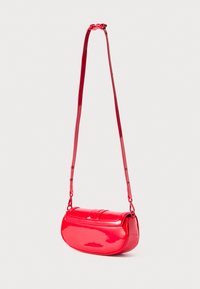 Red patent leather handbag with a rounded shape, slim strap, and flap closure. Smooth texture with minimal hardware and no visible accents.