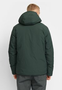 Dark green insulated jacket with a hood, featuring a smooth texture and stitched detailing. Back view shows a straight cut and elastic cuffs.