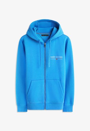 Blauer Kapuzenpullover mit durchgehendem Reißverschluss, Fronttaschen, Kordelzugkapuze und "Tommy Hilfiger"-Logo auf der linken Brust.
