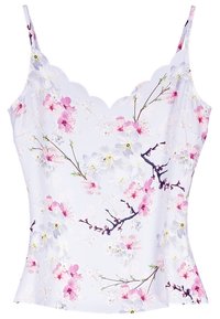 White camisole with scalloped neckline, featuring pink and white cherry blossom floral pattern and thin adjustable straps.