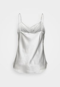 Cowl-neck silken top in light grey with thin, jeweled chains as straps. Smooth texture and flowing design, featuring a rounded hem.