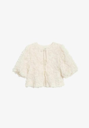 Veste cropped à texture florale blanche avec des manches ballons, dotée d'un col rond et d'une fermeture à lien au dos. Design doux et tridimensionnel.