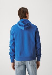 Lacoste Jersey con capucha - ladigue
