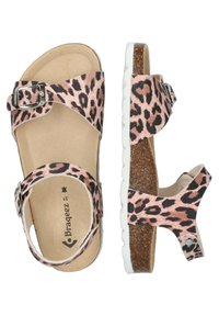 Leopard print sandals with beige and black pattern, adjustable buckle, cork footbed, white textured sole, and open back design.