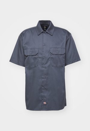 Short-sleeve dark navy shirt made of smooth fabric, featuring a button-up front, two chest pockets, and a small logo on the bottom hem.