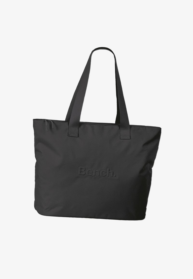 Sac fourre-tout noir en tissu durable, doté de deux poignées robustes et d'un logo en relief sur le devant. Design rectangulaire simple.