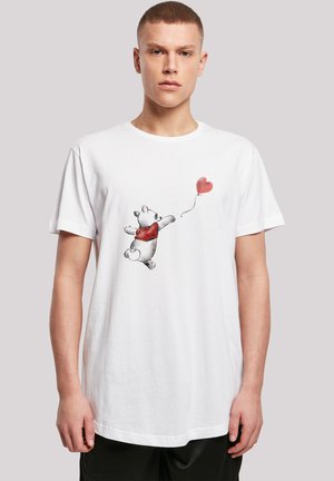 White cotton T-shirt featuring a graphic of a bear wearing a red sweater, reaching for a red heart balloon. Round neck, short sleeves.