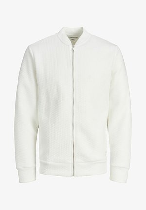 Veste bomber blanche zippée avec un tissu texturé, col et poignets côtelés, dotée d'une fermeture éclair centrale et d'un design minimaliste. Aucune poche visible.