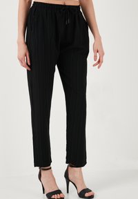 SLIM FIT - Trousers - black