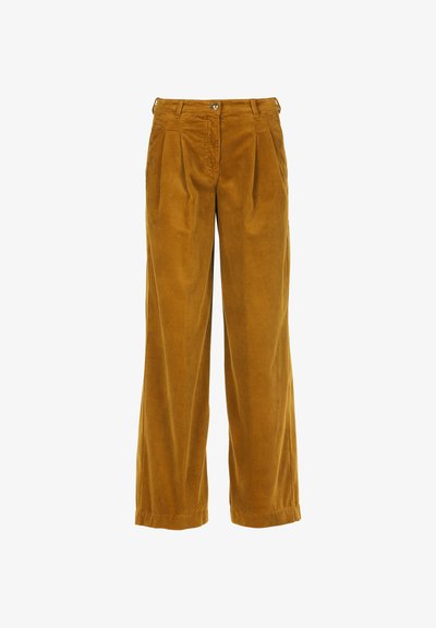 Ženske široke hlače iz kord flisa v gorčično rumeni barvi, s sprednjimi naborki, zadrgo in gumbom za zapiranje ter pasi band. Očitna teksturirana površina.