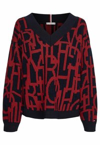 Pullover rouge et marine avec un design en V, présentant un motif abstrait audacieux et des poignets et un ourlet côtelés. Fabriqué en tissu tricoté.