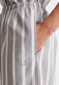 Grau gestreifter Kleid mit rosa Streifen, einem elastischen Taillenbund und Seitentaschen. Auffällige gestickte Initialen "M O P" am Saum.