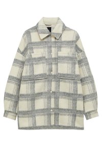 Fleece shirtjack in crème met een grijs geruit patroon, voorzien van een knoopsluiting aan de voorkant, een puntige kraag en twee opgestikte zakken.