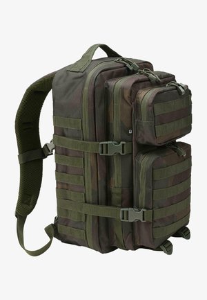 Plecak wojskowy w zielonym kamuflażu. Posiada liczne komory, wytrzymałe zamki błyskawiczne, paski z taśmy nośnej oraz siatkowe wyściółki na pasku na ramię.