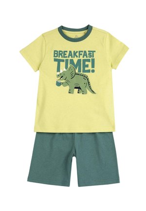 T-shirt di cotone gialla con dettagli verdi, caratterizzata da una grafica di un dinosauro e il testo "ORA DI COLAZIONE!", abbinata a pantaloni corti verdi.