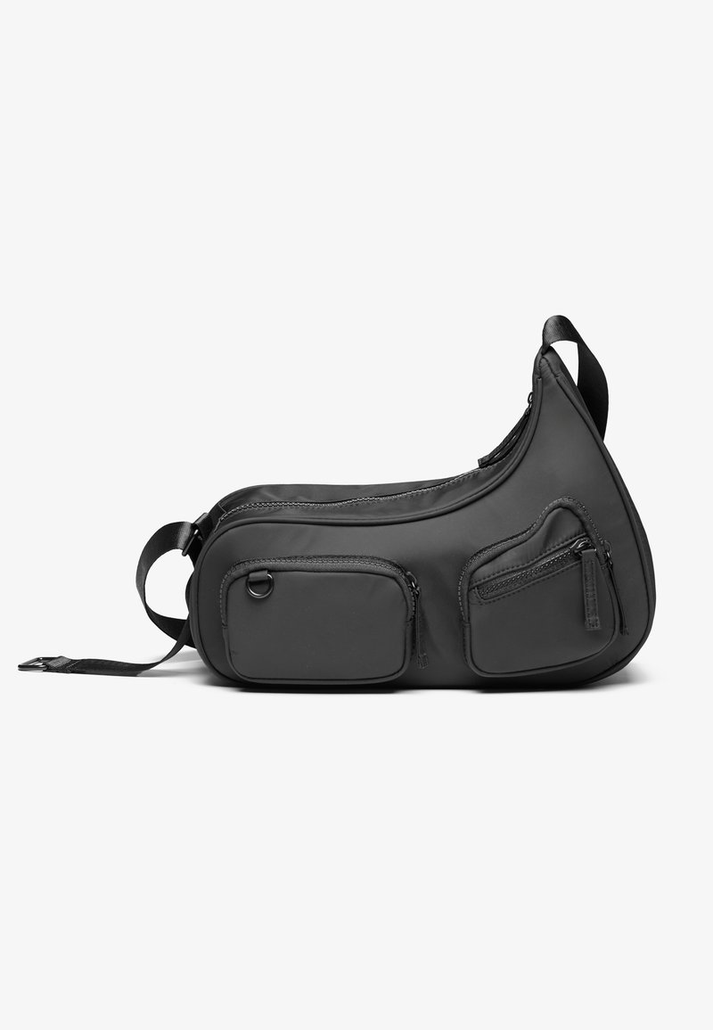 Musthave mustsuurene must vöökott siledast materjalist, kaarjas kuju, kaks lukkudega esikotti, reguleeritav rihm ja nähtamatu riistvara.