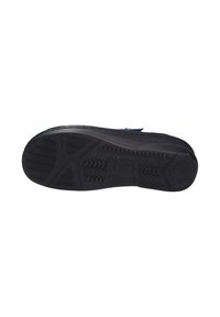 Black shoe sole with textured rubber for grip, featuring a zigzag pattern and grooves. Smooth edges enhance durability.