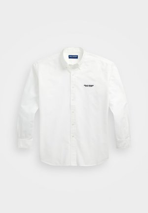 Camicia bianca button-up in cotone con maniche lunghe, caratterizzata da un logo blu e nero "POLO SPORT" nella zona sinistra del petto.