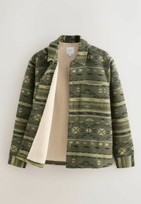 Green patterned flannel shirt jacket with a fleece lining. Features geometric designs in dark green and black, with a collar and one chest pocket.