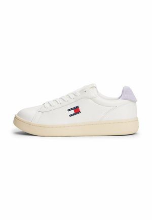 White leather sneaker with round toe, textured off-white sole, and purple suede heel accent. Features a red, white, and blue logo.