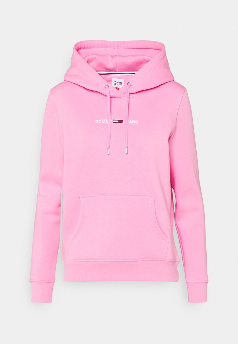 Vaaleanpunainen huppari pehmeästä kankaasta. Siinä on etutasku, säädettävä huppu nauhoilla ja painettu "TOMMY JEANS" -logo tuotemerkin väreissä.