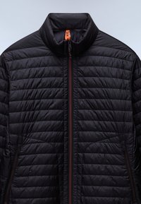 Zwarte geïsoleerde jas met een hoge kraag, voorzien van een horizontaal doorgestikte patroon, twee zippered zijzakken en oranje ritsaccenten.
