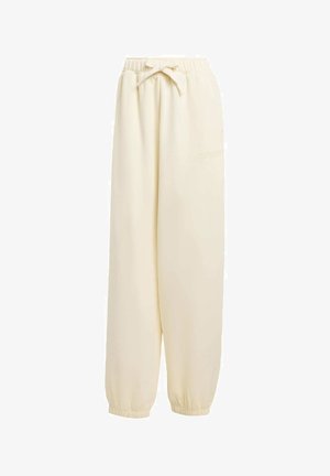 Beige, locker sitzende Sweatpants aus weichem Material. Sie verfügen über einen elastischen Bund mit Kordelzug und elastische Bündchen an den Knöcheln.