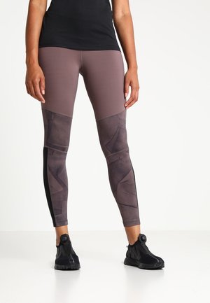 Purple and black leggings featuring a fitted design with geometric patterns, textured fabric, and a solid black side panel.