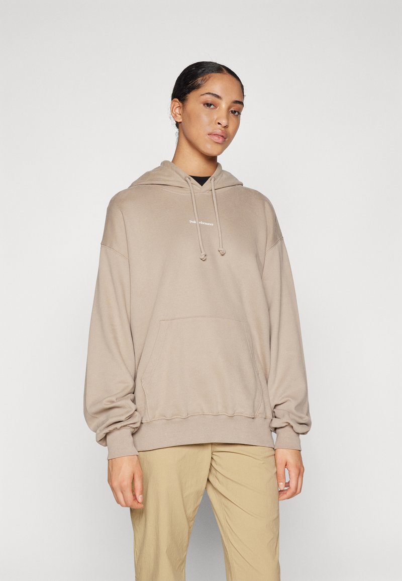 Lichtbruine hooded sweatshirt in een losse pasvorm, met een voorkantzak en verstelbare trekkoorden. Soepele textuur met subtiele branding.