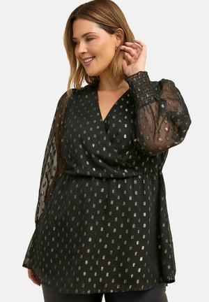 Czarna bluzka z półprzezroczystymi, bufkami, głębokim dekoltem w kształcie V oraz metalicznymi, kropkowanymi wzorami. Materiał ma zwiewną teksturę i elastyczne mankiety.
