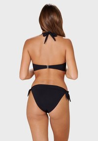 Black bikini set featuring a halter neck top with a tie at the back and low-rise bottoms with side ties. Smooth, matte texture.