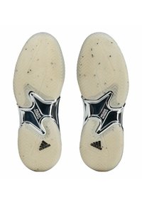 Sole di scarpe sportive bianche con superficie testurizzata, caratterizzate da un intersuola nera lucida con il marchio "TORSION SYSTEM" e il logo Adidas.