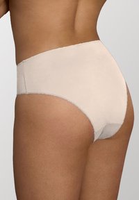 Ogni beige a vita alta con una superficie liscia, fascia elastica e cuciture rinforzate, progettato per il comfort e la copertura.