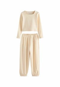 Light beige ribbed two-piece loungewear set. Long-sleeve top with a square neckline; elastic waistband pants with cuffs at the ankles.