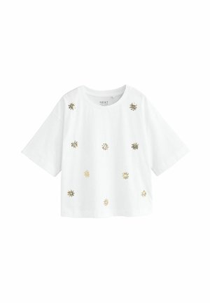 Camicia bianca a maniche corte con scollo rotondo, decorata con piccoli motivi floreali ricamati in oro e argento sparsi sul davanti.