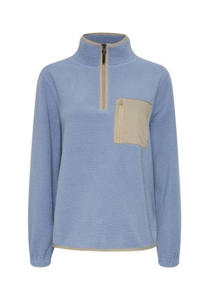 Kék polár pulóver fél cipzárral, bézs mellzsebből, hosszú ujjakkal és struktúrált felülettel. Az alsó részén kontrasztos díszítéssel rendelkezik.