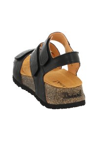 Schwarze Ledersandale mit zwei verstellbaren Riemen, Kork-Zwischensohle und Gummi-Außensohle. Sie verfügt über eine weiche beige Innensohle mit strukturierten Details.