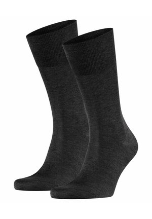 Pair of plain black mid-calf socks with ribbed cuffs, shown against a white background.