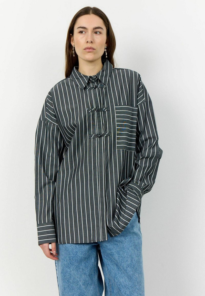 Striped button-up shirt in dark shades with a chest pocket. Features a unique collar and loose fit. Material appears soft with a textured finish.