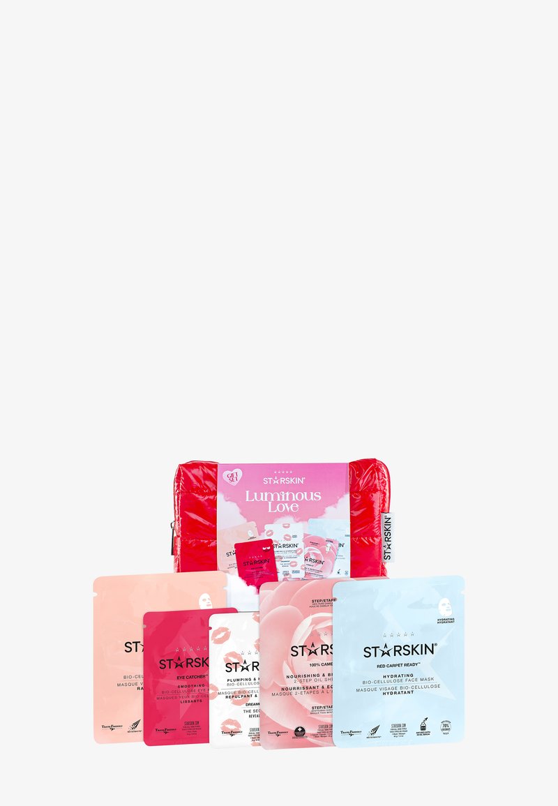 Seks fargerike ansiktsmaske-sachetter arrangert foran en rød kosmetikkpung merket StarSkin med etiketten Luminous Love.