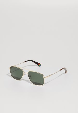 Óculos de sol dourados com lentes retangulares verdes, apresentando aros finos e um detalhe multicolorido nas hastes.