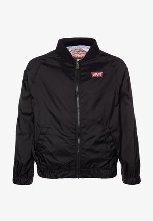 Černá bomber bunda z nylonu s předním zipem, žebrovaným límcem a elastickými manžetami. Na hrudi výrazné červené logo Levi's.