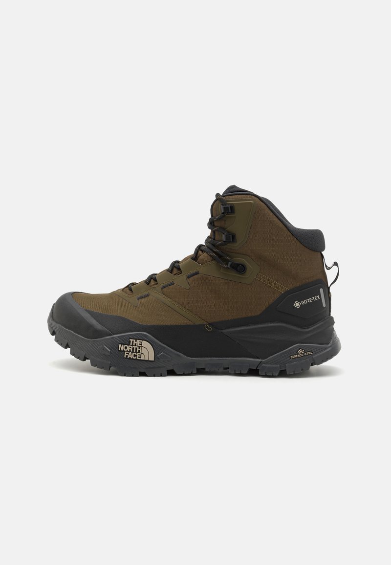 Botas de caminhada impermeáveis em verde oliva escuro e preto, com um cabedal texturizado, sola robusta e biqueira reforçada.